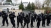 FILE - Police officers stand outside the Russian Embassy during a protest over Russian intelligence services' alleged involvement in an ammunition depot explosion in the Vrbetice area in 2014, in Prague, Czech Republic, April 18, 2021.
