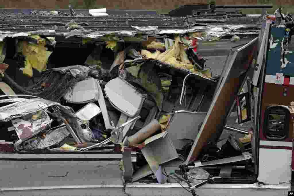 Seats are jammed together with other debris on an upside-down Amtrak train car sitting on a flat bed trailer taken from the scene of Monday's deadly crash onto Interstate 5.
