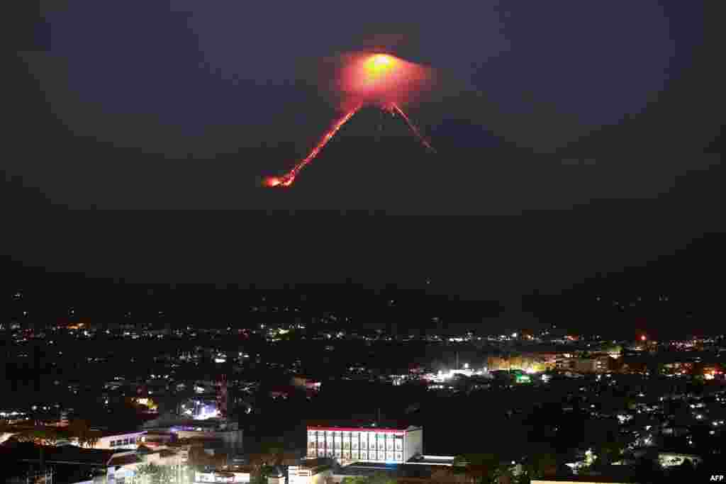 Lava from Mayon volcano is seen as it erupts in Legazpi. The Philippines raised the alert level for the country's most active volcano twice in 24 hours, meaning that a hazardous eruption is possible within days.