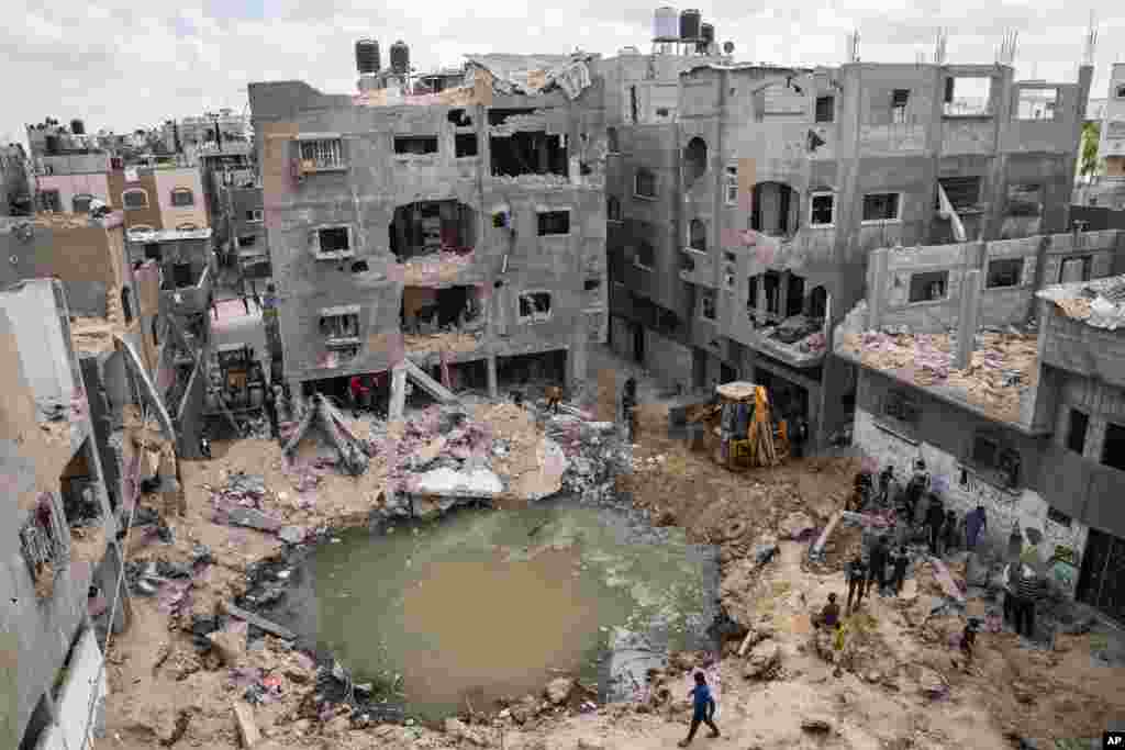 A crater full of water and sewage is seen where the home of Ramez al-Masri was destroyed by an Israeli airstrike in Beit Hanoun, the northern Gaza Strip, after an 11-day war between Gaza's Hamas rulers and Israel.