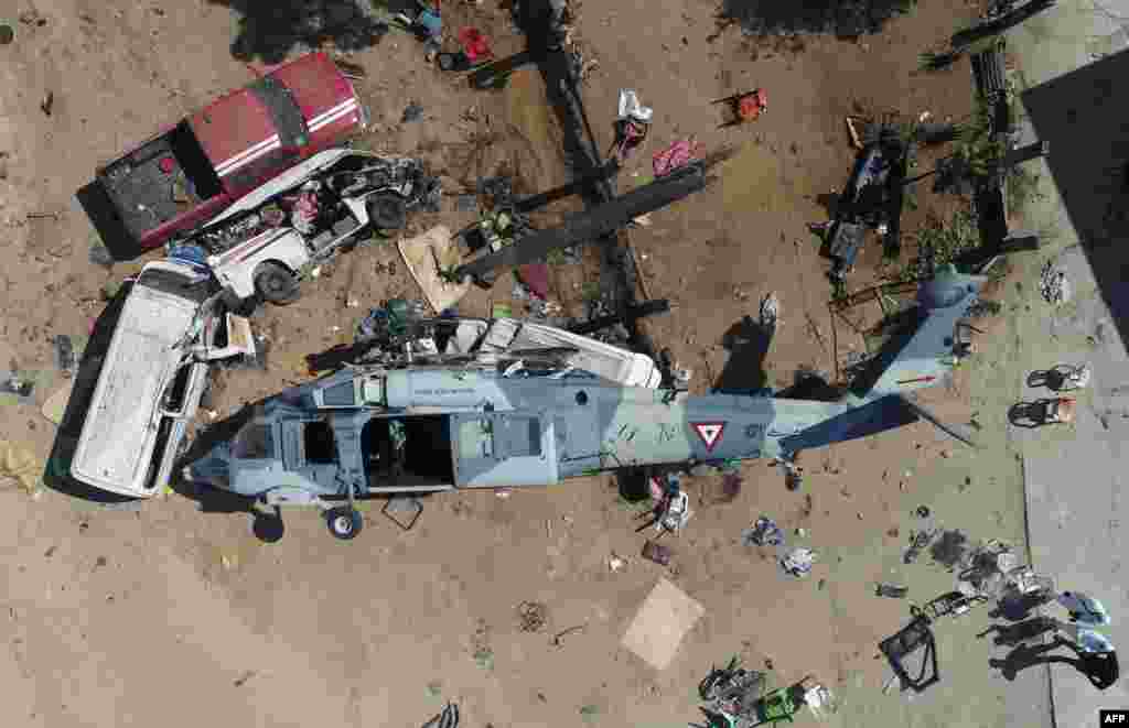 Aerial view of the military helicopter that fell on a van in Santiago Jamiltepec, Oaxaca state, Mexico, Feb. 17, 2018. A 7.2-magnitude earthquake rattled Mexico on Friday, causing little damage but triggering a tragedy when a minister's helicopter crash-landed on the way to the epicenter, Oaxaca, killing 13 people, including three children, on the ground.