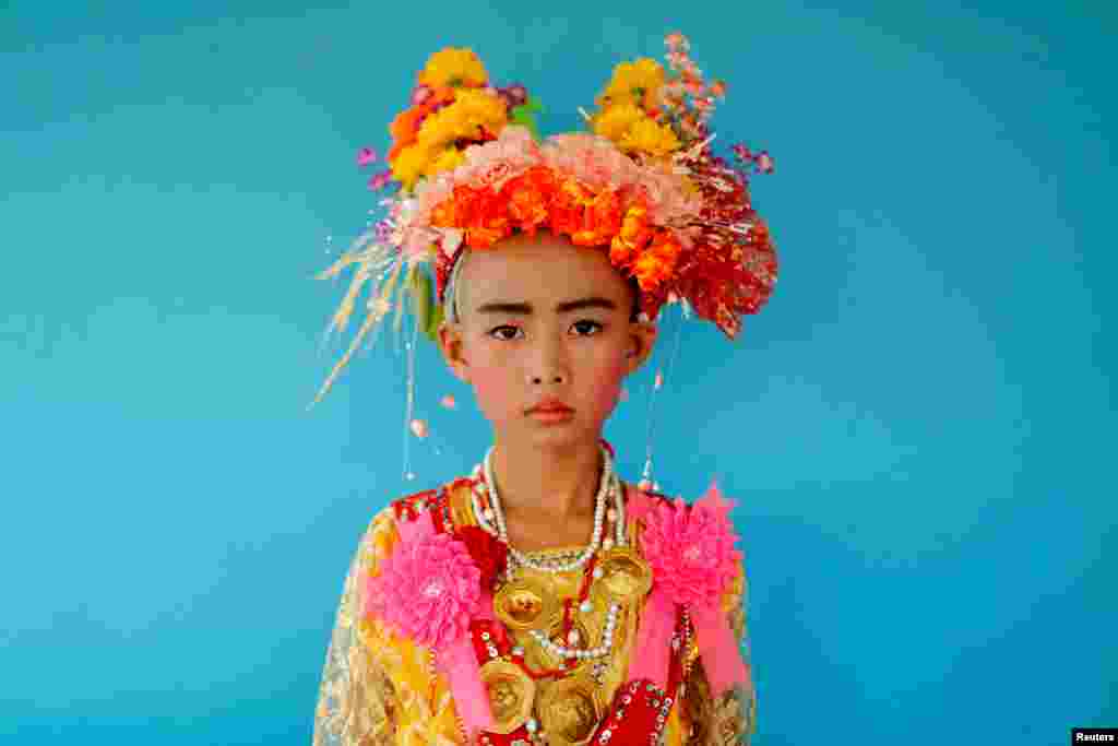 Danusorn Sdisaithaworn, 10, poses for a portrait during an annual Poy Sang Long celebration, a traditional rite of passage for boys to be initiated as Buddhist novices, while he visits a relative's house outside Mae Hong Son, Thailand.