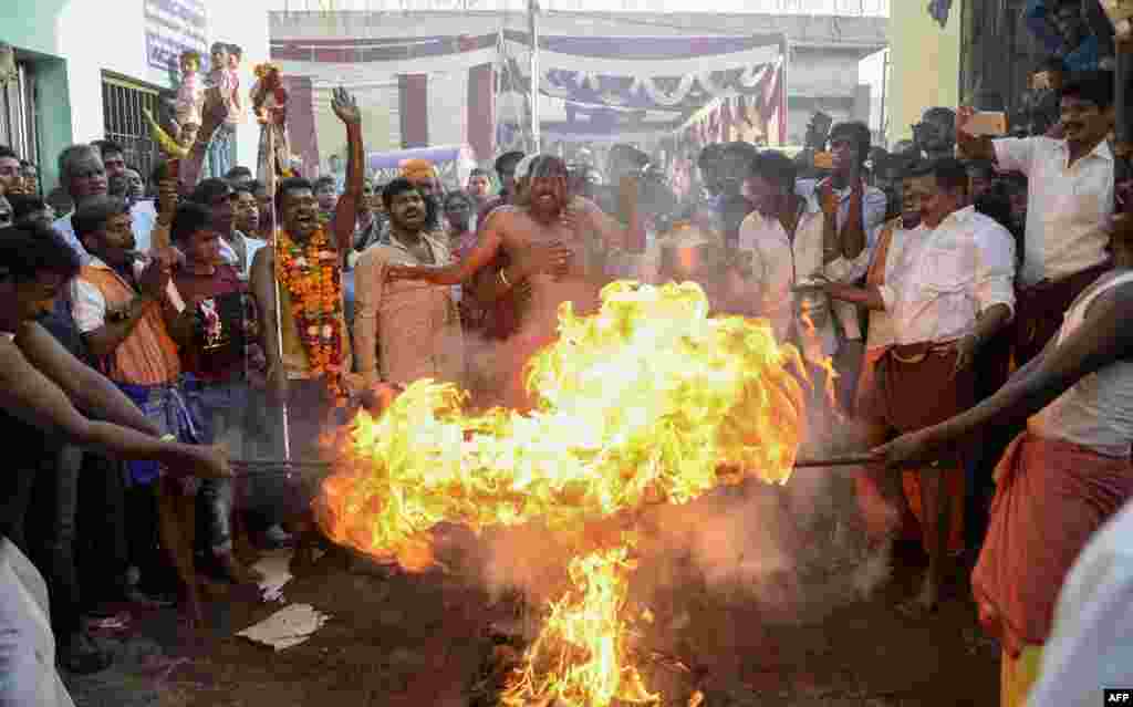 Indian Tamil Hindu devotees perform a ritual during the 'Panguni Uthiram' festival in Jalandhar. The festival is observed in the Tamil month of Panguni and is celebrated to honour the Hindu God Murugan. Devotees make offerings through sacrificial feats they believe will keep them away from evil spirits.