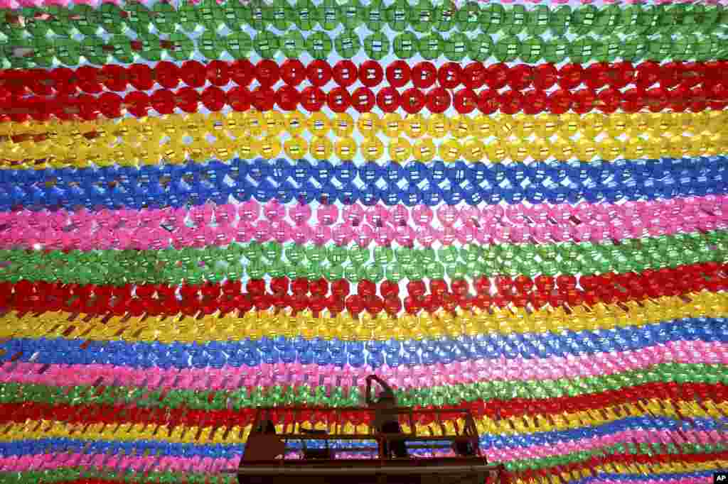 A worker attaches the name tag of a Buddhist who made donation to a lantern for the upcoming celebration of Buddha&#39;s birthday at the Jogye temple in Seoul, South Korea.