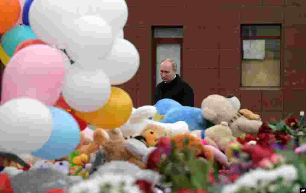 Russian President Vladimir Putin lays flowers at a memorial for the victims of a fire in a multi-story shopping center in the Siberian city of Kemerovo, about 3,000 kilometers (1,900 miles) east of Moscow, Russia.