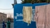 FILE - People walk past an African National Congress (ANC) poster in the run up to May 8 elections in Johannesburg, April 28, 2019.