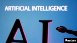 Ілюстративне фото. Напис AI (Artificial Intelligence, у перекладі Штучний Інтелект) та мініатюрна рука робота. Фото REUTERS