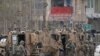 FILE - NATO soldiers inspect near the site of an attack in Kabul, Afghanistan, March 25, 2020.