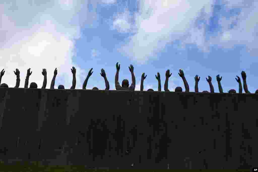 This photo shows a bronze statue called "Raise Up" as part of the display at the National Memorial for Peace and Justice, a new memorial to honor thousands of people killed in racist lynchings, April 23, 2018, in Montgomery, Alabama.