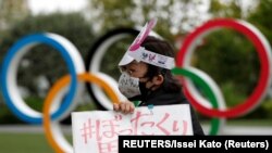 日本东京要求取消东京奥运会的人士在奥运五环前举行抗议。（ 2021年5月18日）