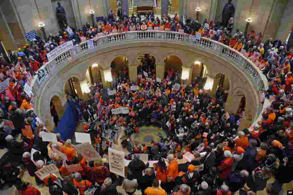 Hundreds gather in the State Capitol rotunda during a rally Thursday, Feb. 22, 2018 in St. Paul, Minn., where concerned citizens are calling for the passage of four bills they believe would substantively reduce gun violence in the state.