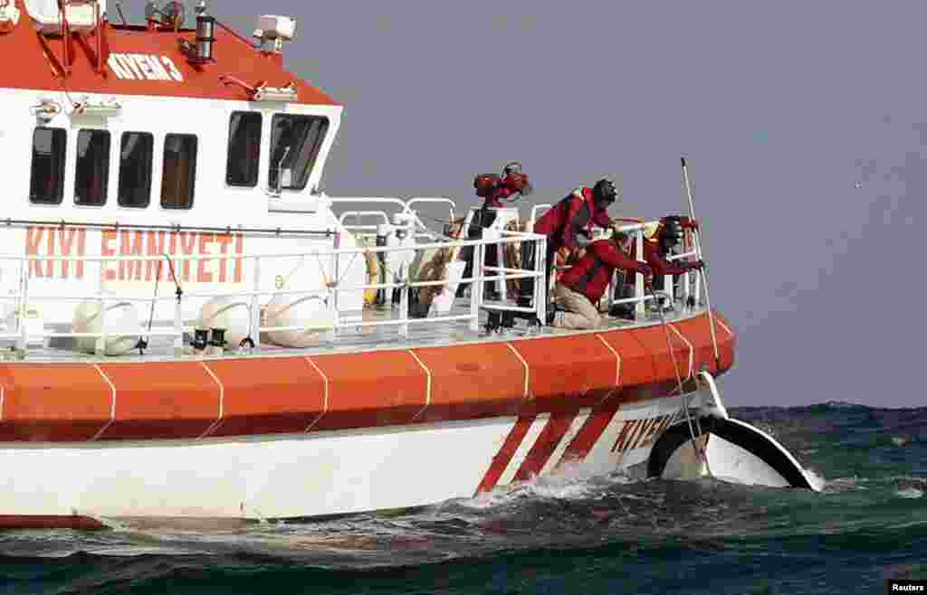 Rescuers retrieve a boat that sank off the Black Sea village of Garipce, near Istanbul, Turkey, Nov. 3, 2014.