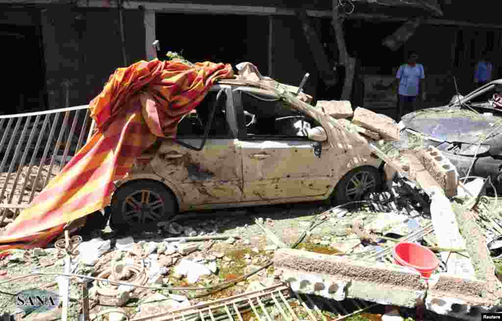 A view shows the wreckage after a car bomb exploded in the Jaramana district of southeast Damascus September 3, 2012, in this photograph released by Syria's national news agency SANA.