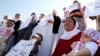 Yazidi women cry as they attend a demonstration at a refugee camp in Kurdish-dominated city of Diyarbakir, Turkey, to mark the second anniversary of what a U.N.-appointed commission of independent war crimes investigators termed a genocide against the Yazidi.