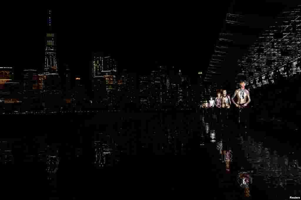 Models present creations from the Saint Laurent Men's Spring Summer 2019 collection during a runway show in Liberty State Park in New Jersey, June 6, 2018.