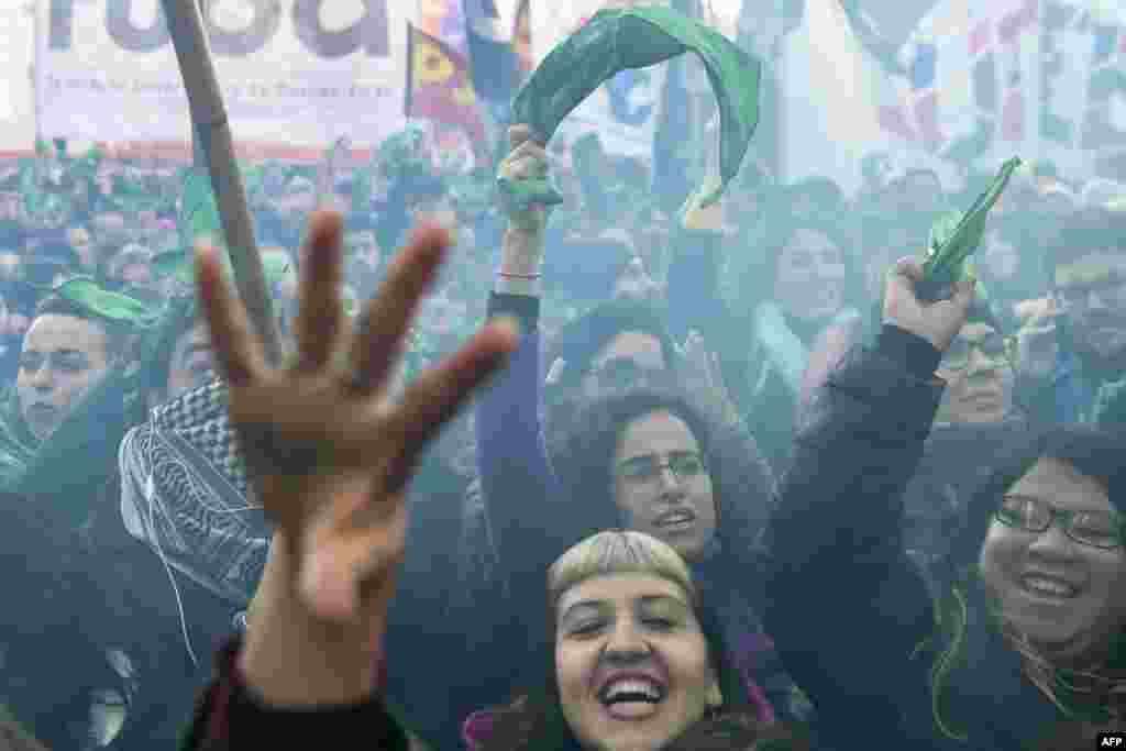 Pro-choice activists react outside the Argentine Congress in Buenos Aires shortly after lawmakers approved a bill to legalize abortion.