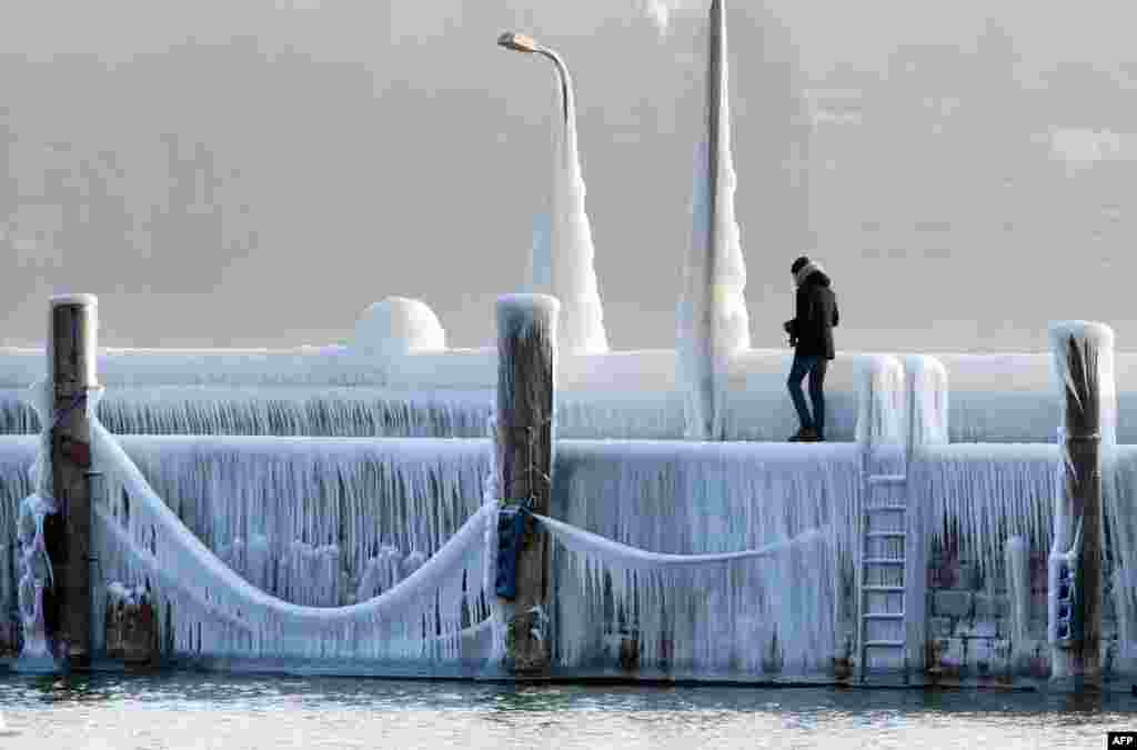 A man walks along the Lake Constance covered with ice and icicles in Constance, Germany, as a blast of Siberian weather dubbed the "Beast from the East" kept the mercury far below zero in huge parts of Europe.