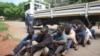 A policeman stands guard as some of the people arrested during demonstrations over the hike in fuel prices, make their court appearance at the magistrates courts in Harare, Zimbabwe, Wednesday, Jan,16, 2019. 