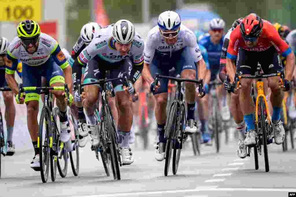 Peter Sagan of Slovakia (2ndL) sprints to win ahead of second-placed Sonny Colbrelli of Italy (FarR) and third-placed Patrick Bevin of New Zealand (2ndR) at the arrival of the stage 2, 168.1 km from Aigle to Martigny during the Tour de Romandie UCI World Tour 2021 cycling race in Martigny, Switzerland.