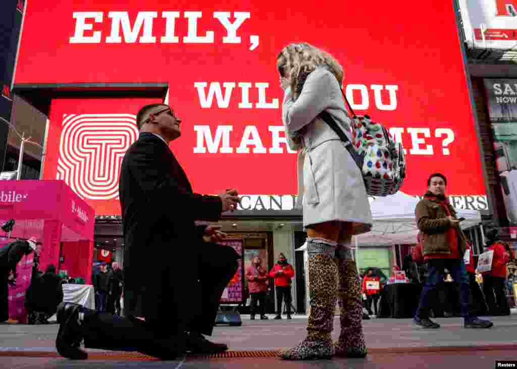 Joe lodato proposes to Emily Gambarella on Valentine's Day in Times Square in New York, Feb. 14, 2018.