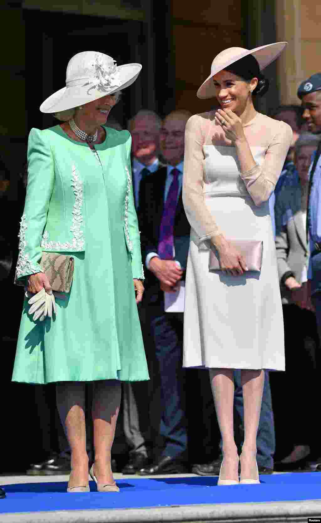Meghan, Duchess of Sussex attends a garden party at Buckingham Palace, with Camilla the Duchess of Cornwall, in London, Britain May 22, 2018.