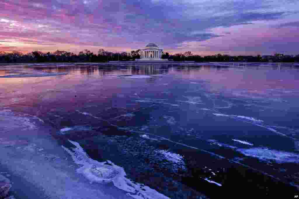 2018年1月8日，冬日的黎明，华盛顿西侧的潮汐湖（Tidal Basin）结冰，湖畔的杰佛逊纪念堂在湖面留下倒影。天光云影共徘徊。