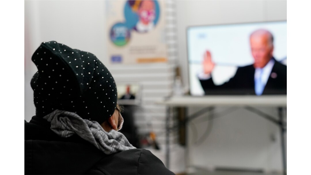 Blanca Cedillos, left, a nanny from El Salvador, watches President Joe Biden's swearing-in ceremony at the Workers Justice Center, an immigrants rights organization, in Brooklyn in New York, Jan. 20, 2021.