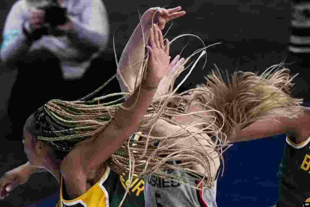 Baylor's DiJonai Carrington shoots past UConn's Paige Bueckers during the second half of an NCAA college basketball game in the Elite Eight round of the Women's NCAA tournament, March 29, 2021, at the Alamodome in San Antonio, Texas.