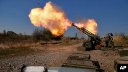 На фото 14 жовтня 2014 року російські проксі обстрілюють українські позиції в Донецькому аеропорту. Росія приховувала, що надсилала зброю та війська для війни проти України до 2022 року, а про тисячі убитих казали, що вони загинули у навчаннях у Ростовській області Росії. (AP)