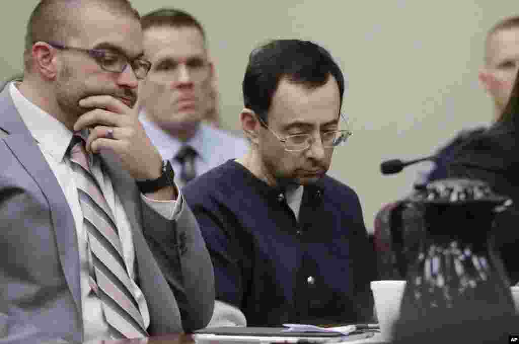 Larry Nassar sits with attorney Matt Newburg during his sentencing hearing in Lansing, Michigan. The former sports doctor who admitted molesting some of the nation's top gymnasts for years was sentenced 40 to 175 years in prison as the judge declared: "I just signed your death warrant." The sentence capped a remarkable seven-day hearing in which scores of Nassar's victims were able to confront him face to face in the Michigan courtroom.