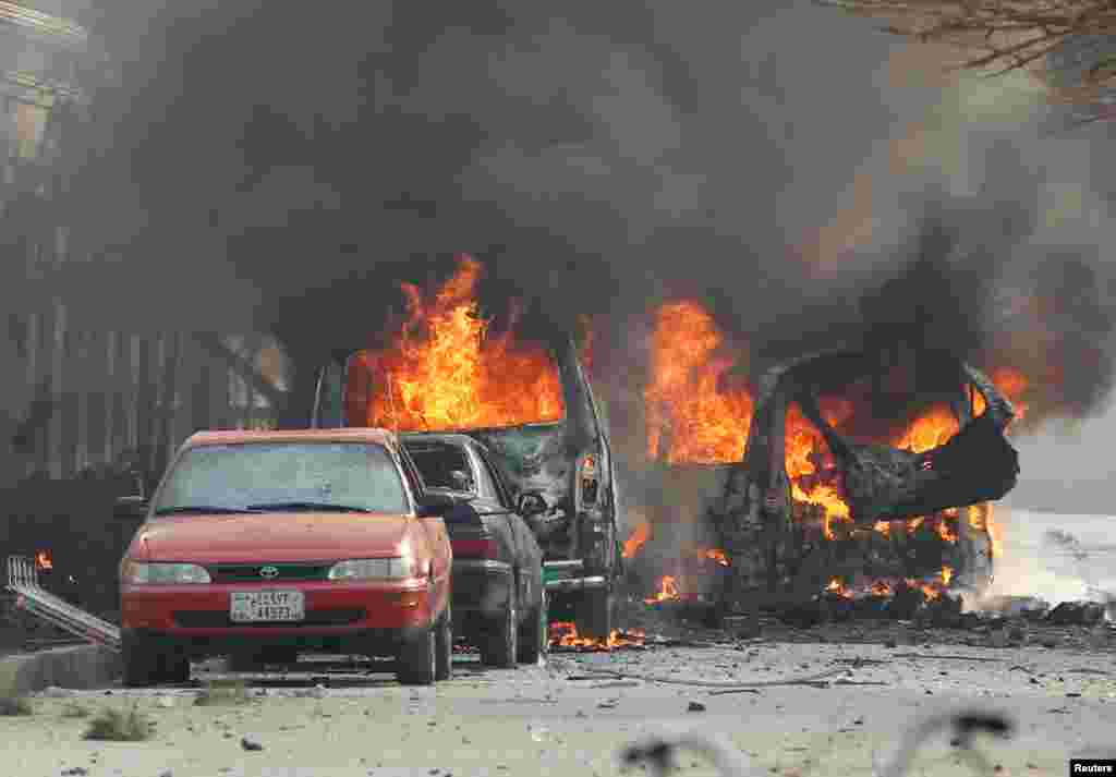 Vehicles are seen on fire after a blast in Jalalabad, Afghanistan.