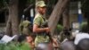 FILE - Tanzanian police stand guard in Dar es Salaam, Tanzania, Oct. 28, 2015. 