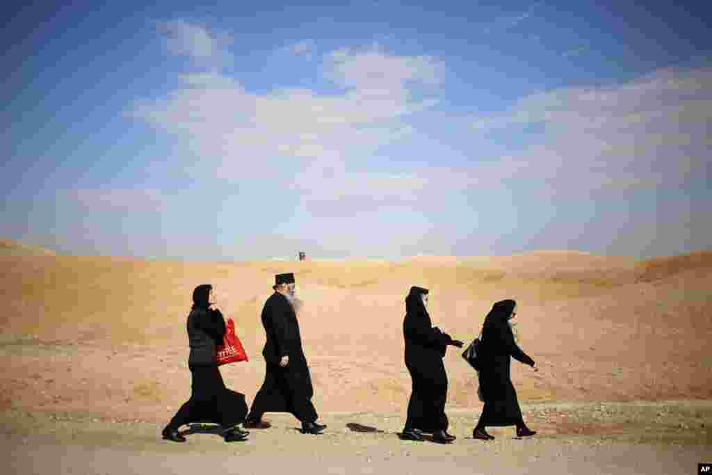Israel Palestinians Christians walk to the traditional Epiphany baptism ceremony at the Qasr-el Yahud baptism site, in the Jordan river near the West Bank town of Jericho. The site is traditionally believed by many to be the place where Jesus was baptized