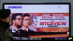 韩国一名军人走在首尔火车站索尼公司影片【采访】的电视广告屏幕附近。