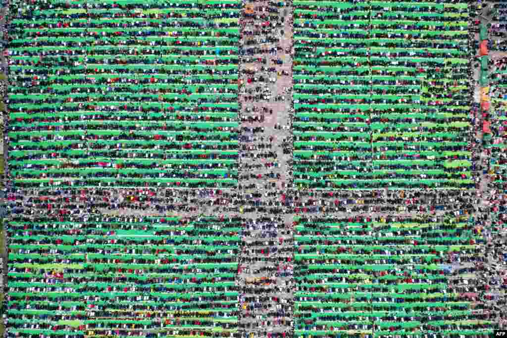 Albanian Muslims pray at Skenderbej square on the first day of the Muslim festival marking the end of the holy fasting month of Ramadan, in Tirana.