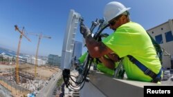 电信工人为AT&T在美国加利福尼亚州圣地亚哥市中心的5G无线网络安装了一个由爱立信制造的5G天线系统。(2019年4月23日)