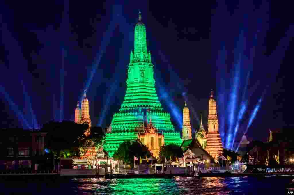 The stupa of the Buddhist temple Wat Arun (Temple of Dawn) is illuminated in green to mark St. Patrick's Day in Bangkok.
