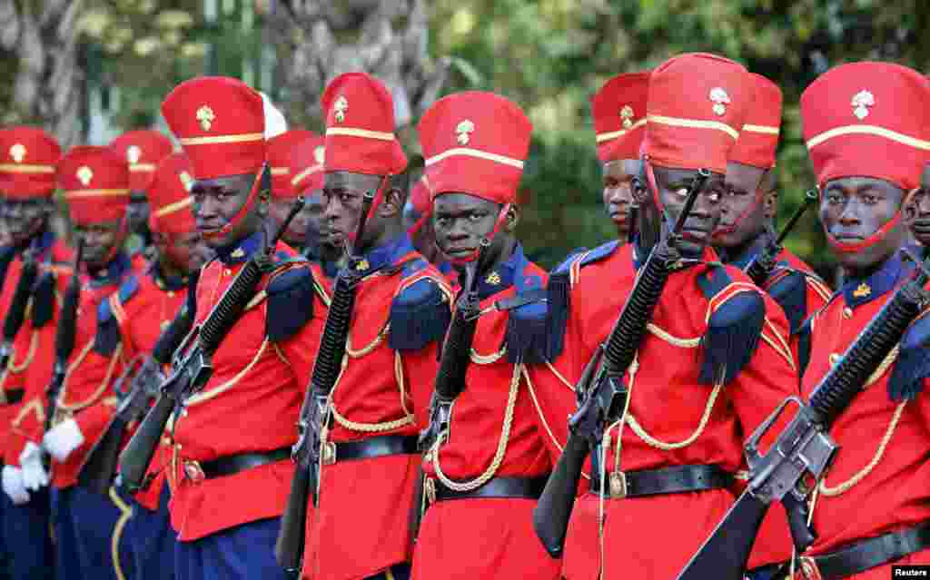 Senegalese troops stand at the presidential palace in Dakar before the arrival of the French President who meets with his Senegalese counterpart in Dakar.