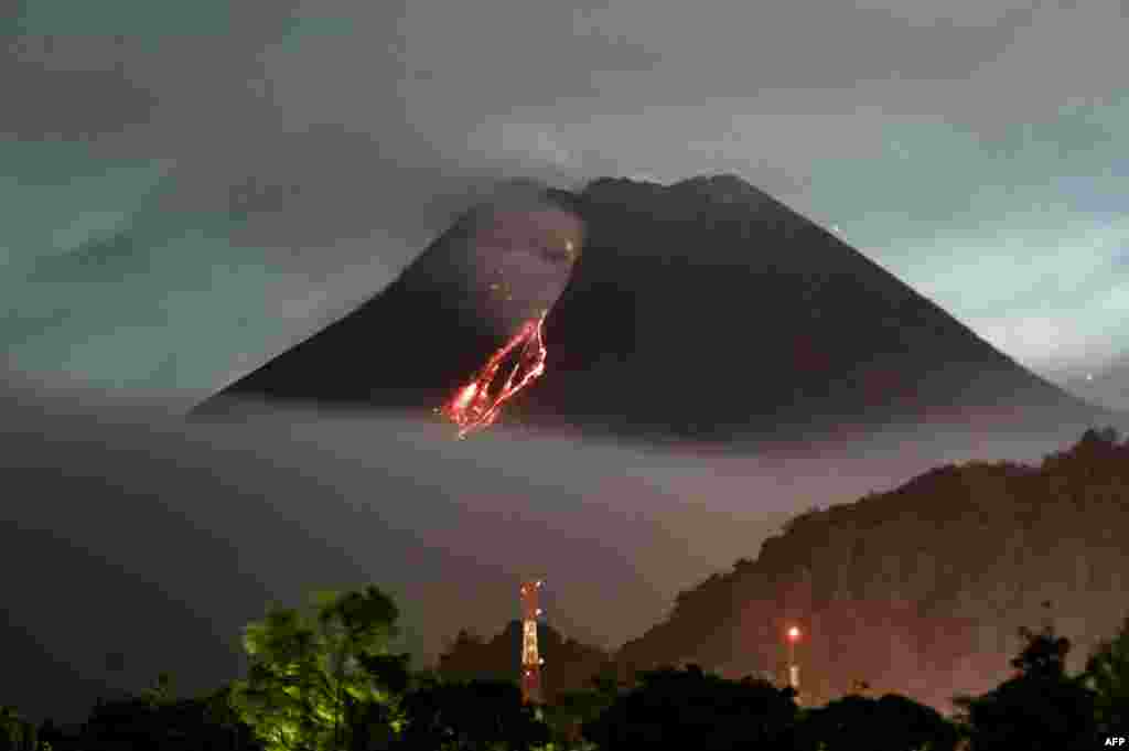 Lava flows down from the crater of Mount Merapi, Indonesia's most active volcano, as seen from Kaliurang in Yogyakarta.