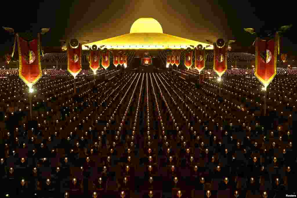 Thousands of believers join Buddhist monks praying at the Wat Phra Dhammakaya temple during a ceremony on Makha Bucha Day in Pathum Thani, Thailand.