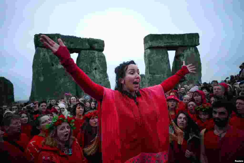 Revellers celebrate as the sun rises during the winter solstice at Stonehenge on Salisbury Plain in southern England, Britain.