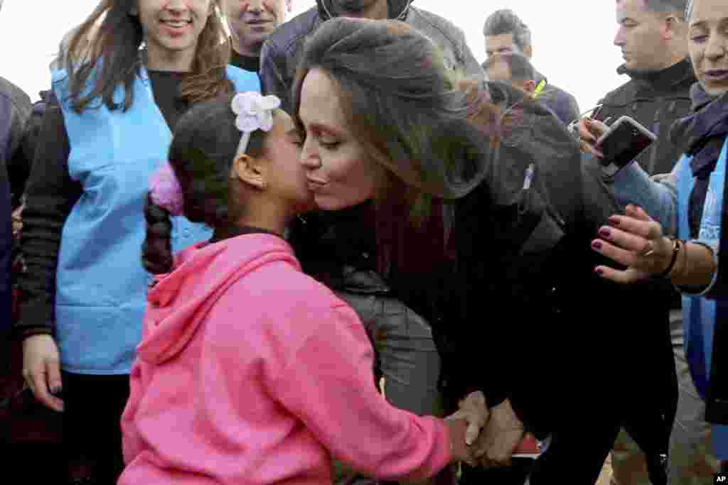 The U.N. refugee agency's special envoy, actress Angelina Jolie, kisses a Syrian child during her visit to the Zaatari Syrian Refugee Camp, in Mafraq, Jordan.