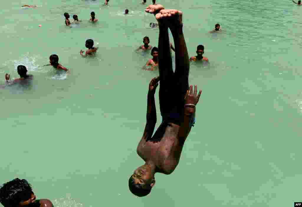 Indian youths swim during a hot day in Chennai.