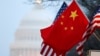 The People's Republic of China flag and the U.S. Stars and Stripes fly along Pennsylvania Avenue near the U.S. Capitol in Washington during Chinese President Hu Jintao's state visit