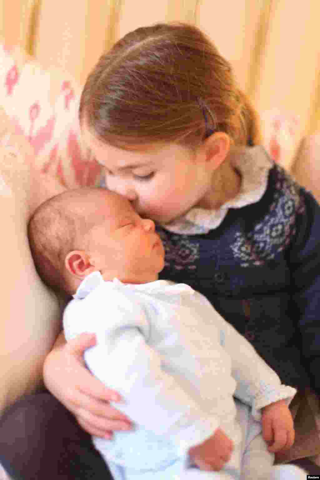 Britain's Princess Charlotte and her brother Prince Louis are seen in this photograph released by Kensington Palace, and taken by Britain's Catherine, Duchess of Cambridge, on Princess Charlotte's third birthday, at Kensington Palace in London.