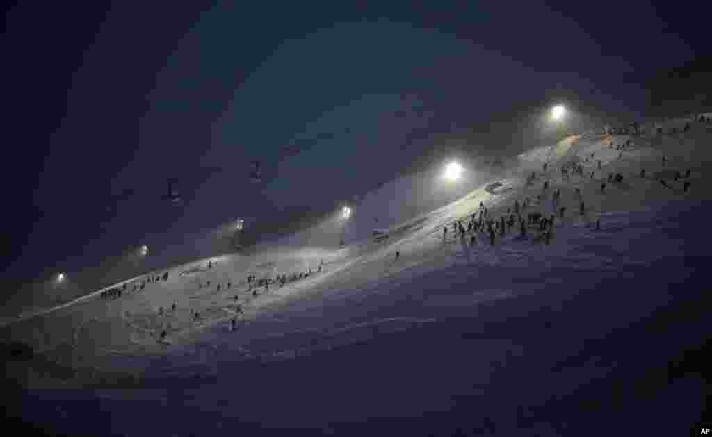 Race inspectors check out the course ahead of an alpine ski, men's World Cup slalom, in Val D'Isere, France.