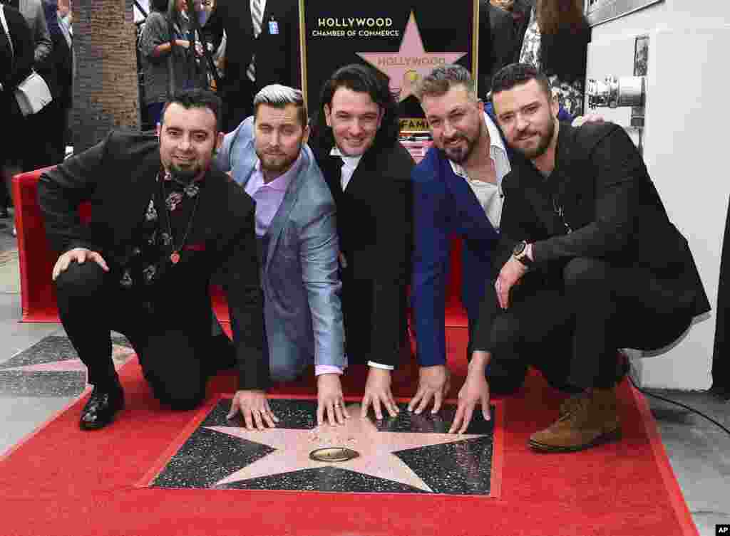 Chris Kirkpatrick, from left, Lance Bass, JC Chasez, Joey Fatone and Justin Timberlake of the band NSYNC appear at a ceremony honoring them with a star on the Hollywood Walk of Fame, April 30, 2018, in Los Angeles, California.
