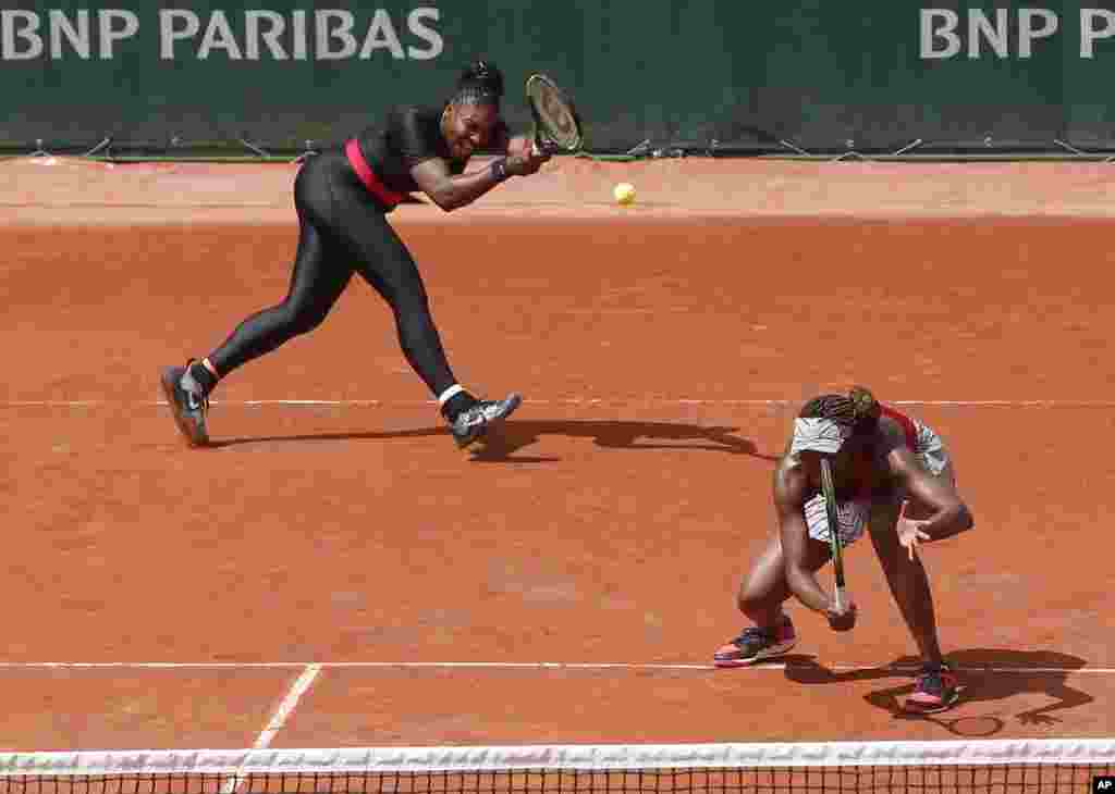 Venus, right, and Serena Williams of the U.S. return a shot against Japan's Shuko Aoyama and Miyu Kato during their first round match of the French Open tennis tournament at the Roland Garros stadium in Paris, France.