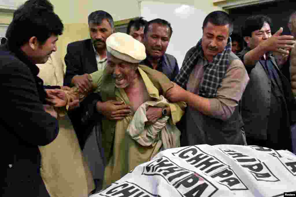 A father of a member of Hazara community, who was killed with along others by unidentified gunmen, mourns the death of his son at hospital in Quetta, Pakistan.