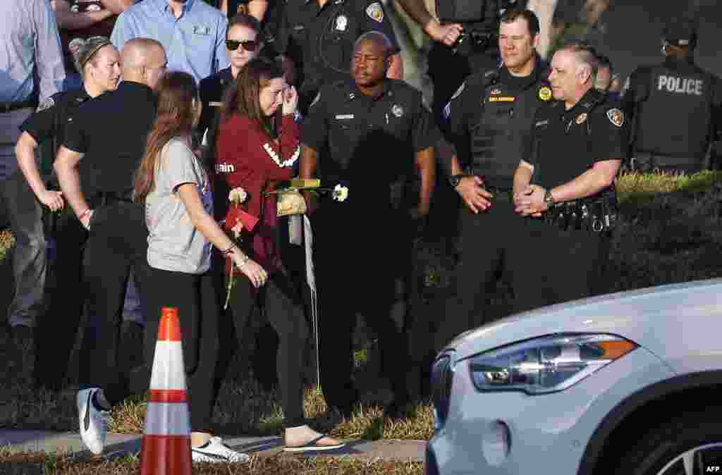 Marjory Stoneman Douglas High School staff, teachers and students who return to school are greeted by police and well wishers in Parkland, Florida. The community of Parkland steeled itself for the resumption of classes at Marjory Stoneman Douglas High School, where nearby flower-draped memorials and 17 white crosses pay tribute to the 14 students and three staff members who were murdered by a former student.